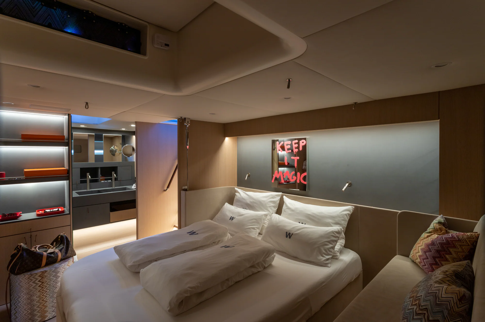 The full-beam master suite aboard Sailing Yacht W, warm, detailed interior
